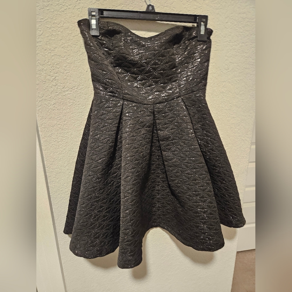 A short black strapless sparkly dress